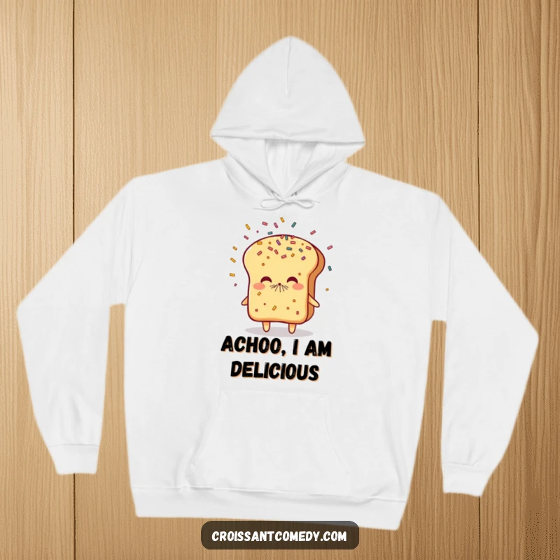 Funny Sneezing Bread Hoodie: A flaky bread character sneezes a joyful shower of sprinkles, offering warm and humorous comfort.