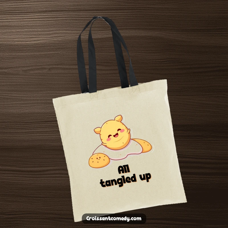 Funny Crescent Roll Tote Bag: A smiling crescent roll character is shown in a fun, head-over-crust tumble with pure glee.